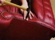 Chesterfeild diivani sügav volditud nööpidega esiserva ääristamine ilunaeltega